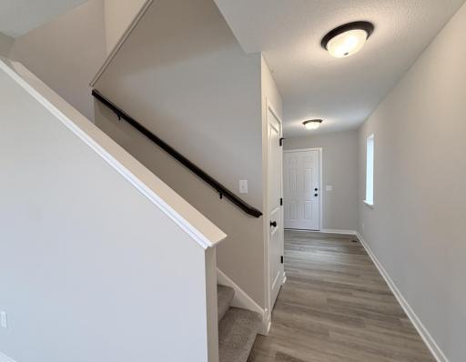 PHOTO OF A DIFFERENT HOME WITH SIMILAR PLAN AND FINISHES. Staircase and foyer.