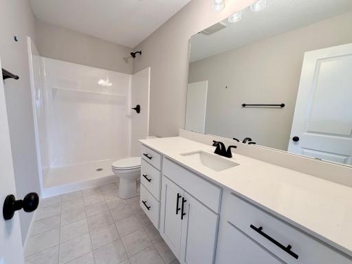 PHOTO OF A DIFFERENT HOME WITH SIMILAR PLAN AND FINISHES. Primary Suite Private Bath.