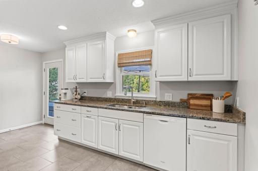 Light and bright kitchen steps out to deck and private backyard