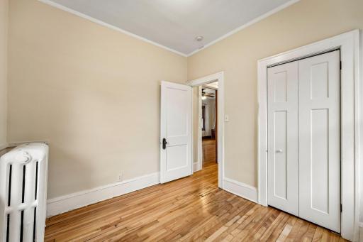 Additional bedroom view with hardwood floors and closet space