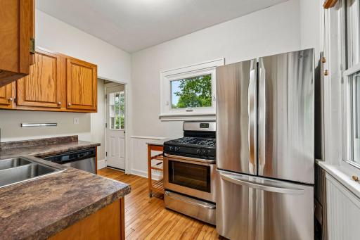 Functional kitchen with wood cabinetry and stainless appliances