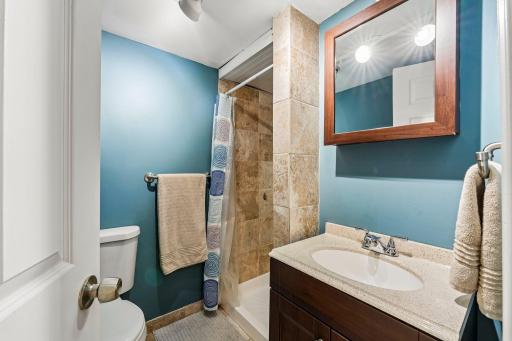 Additional bathroom with tiled shower surround and vanity