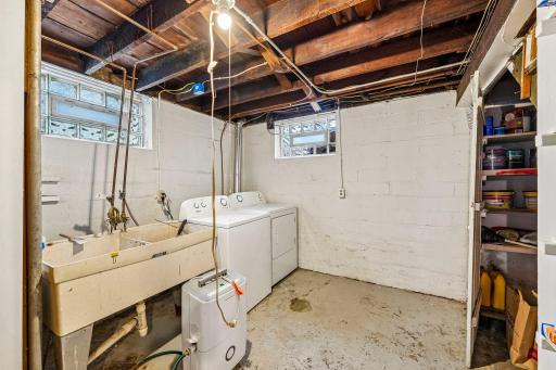 Dedicated laundry area with utility sink and storage space