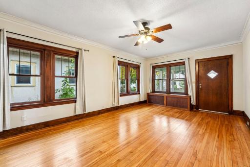 Sun-filled living room with windows on multiple sides