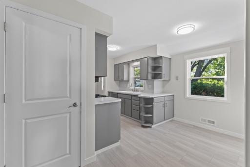 An open view into the kitchen and dining area shows how easily the main-level spaces connect. This convenient door leads you to the large lower level.
