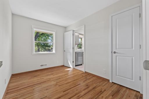Bright main-level bedroom with refinished hardwood flooring, fresh paint and a new window along with a large closet. This space could also be used as a more formal dining room.