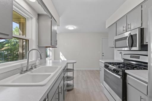A functional kitchen layout offers plenty of counter space, cabinetry and an easy connection to the dining area. Enjoy your beautiful backyard views from the large kitchen sink window.
