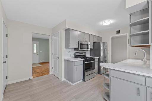 Stainless steel appliances complete the kitchen, including a refrigerator, microwave and dishwasher that have never been used.