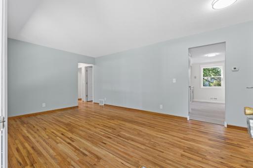 The refinished hardwood flooring continues throughout the main living areas, preserving some of the home's original character.