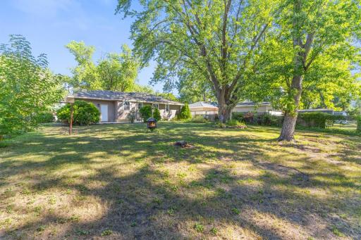Mature trees create a beautiful backdrop for the spacious backyard with plenty of usable lawn.