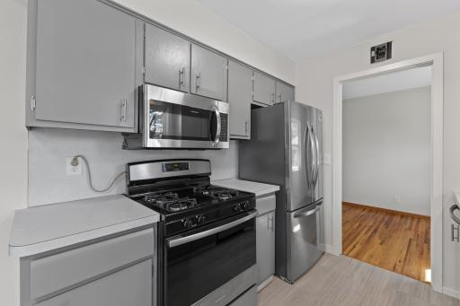 The newer stainless steel appliance package is complemented by a gas range installed in 2023.