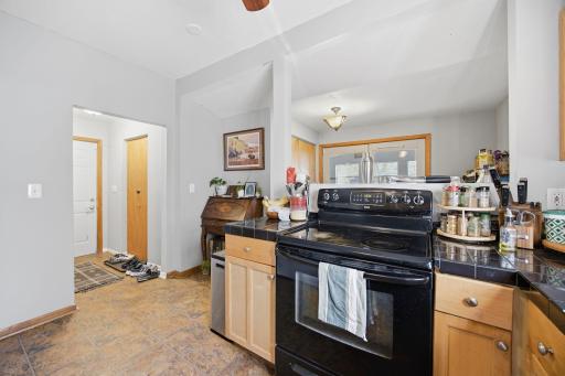 Electric stove, doorway leads to huge storage closet, 3/4 main floor bathroom and the white door leads to the driveway.