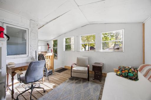 Spacious 3 season porch with access to basement and back yard. Facing south. Updated windows.