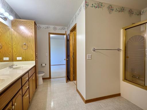 Primary bathroom with custom cabinets, dual sinks and walk in closet.