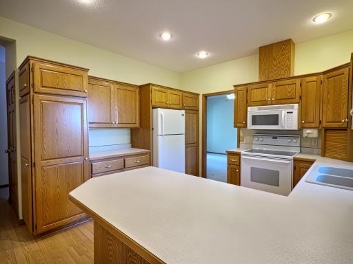 Kitchen boasts ample custom cabinetry for plenty of storage and plenty of counter top work space and view of the lake!!