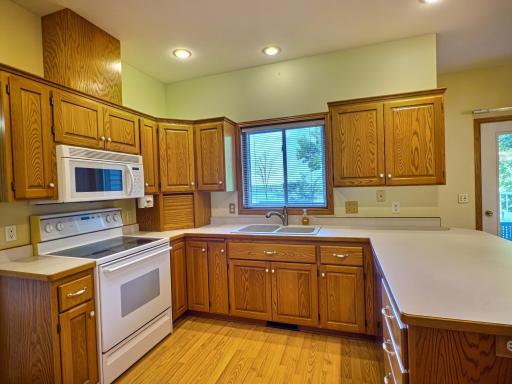 2nd photo of the kitchen showing the window that overlooks the lake.
