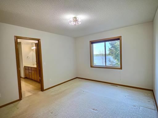 The second upper level bedroom with access to the pass through primary bathroom. Nice lake view from this bedroom.