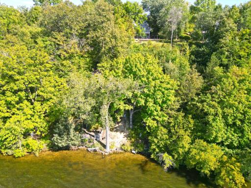 The setting of the 150 feet of shoreline is private with mature trees surrounding it creating a nice private spot at waters edge.