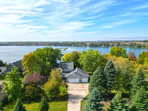 Aerial view of the home and lake wonderful setting with a nice blend of privacy and natural beauty.