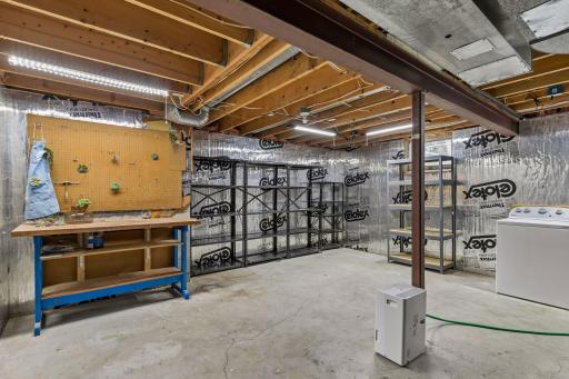 Oversized basement laundry, storage, and workroom