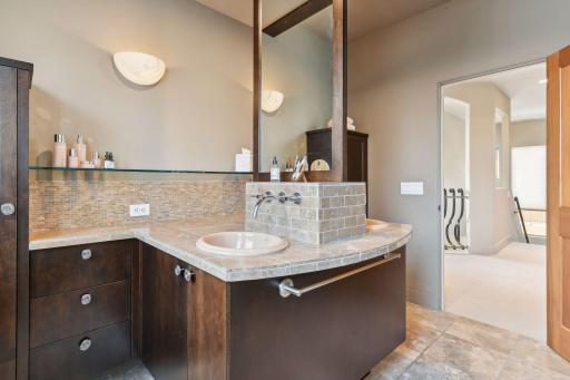 Double sinks, plenty of counter space, and ample storage cabinets in the 3/4 upper level bathroom