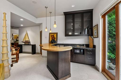 The lower level offers entertaining space, a wet bar, exercise room, and access to the walkout patio area