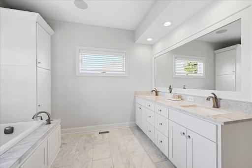 Double sink vanity and quartz tile and in-floor heat in the primary bath
