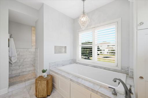 Separate soaking tub and shower in the primary suite