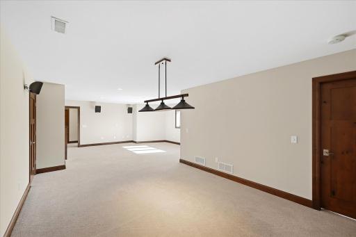 Spacious lower level family room plumbed for a wet bar