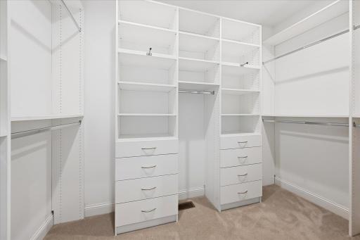 Walk in primary suite closet with adjustable organizers