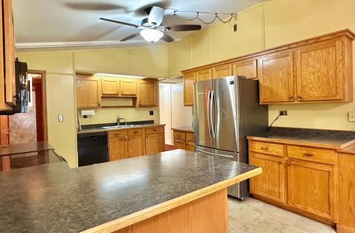 Newer custom cabinets and some newer stainless appliances accessorize the kitchen well.
