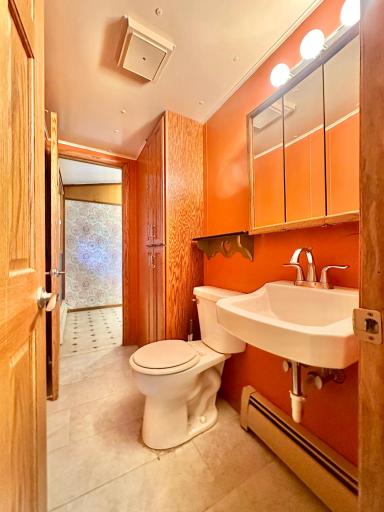 This half bath is also right off the back yard access, between the kitchen and the back entry.