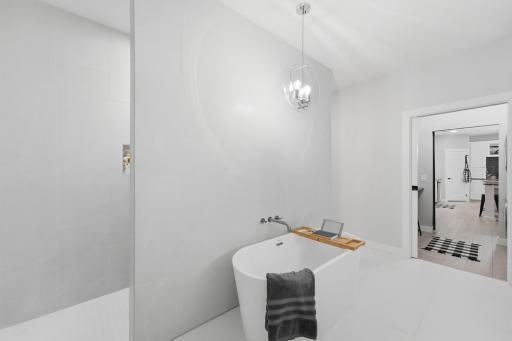 Zero-entry walk-in shower with niche shelving and a bench