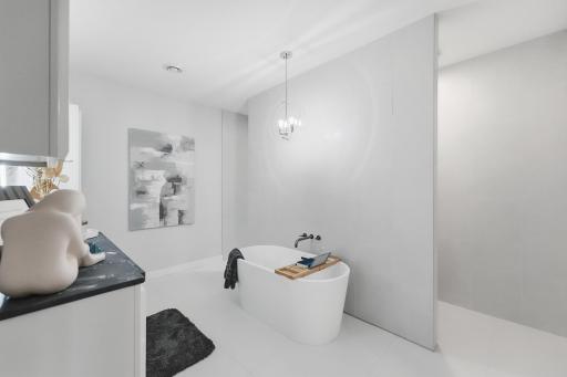 The primary suite is complimented by a spa-inspired bath with a modern aesthetic & unmistakable luxury-hotel feel. A deep, freestanding soaking tub & zero-entry shower create a serene retreat, sophistically finished with floor to ceiling tile.