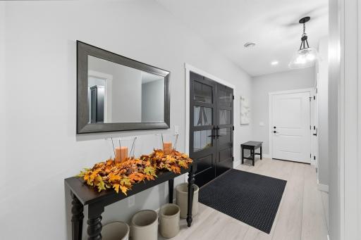 Bayer Built Fiberglass French Entry Door with 3-panel glass details, access to garage, coat closet with custom hang & shelving. Well-lit and room for bench seating to slip on/off your shoes & table to drop your bags & keys. Noise-reduction insulation