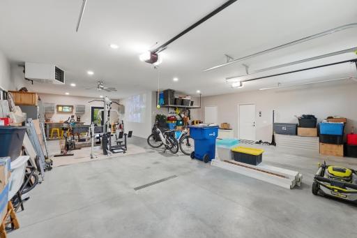 Meticulously clean garage, Reznor heater, floor drains, wash tub, access to mechanical room, tandem layout, ceiling fan, wall for projector TV, access to back patio, hanging ceiling storage, painted, baseboard trim.