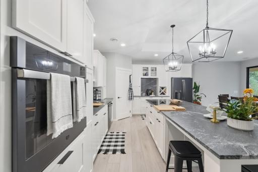 GE Wall Oven, Refrigerator & dishwasher. Kenmore Cooktop 5-burner, Kraus single basin deep SS sink with cutting board & drying rack accessories, American Standard commercial faucet. Walk-in pantry with upgraded shelving. Wine rack and coffee bar.