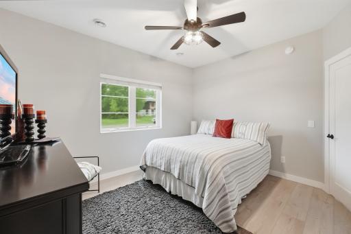Comfortable main-level bedroom with neutral finishes, generous natural light and barndoor to closet. Wifi ceiling fan and light.