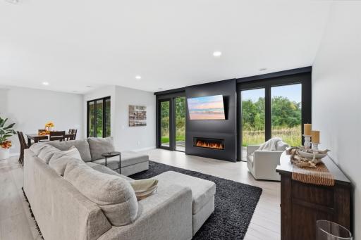 8' floor to ceiling windows. 85% UV protection motorized blinds. Custom metal wall with Dimplex electric fireplace.