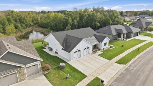 Huge concrete driveway and wrap-around sidewalk back patio extends universal design to outdoor living. Thoughtful rooflines and gutters direct precipitation away from walkways and foundation of the home.