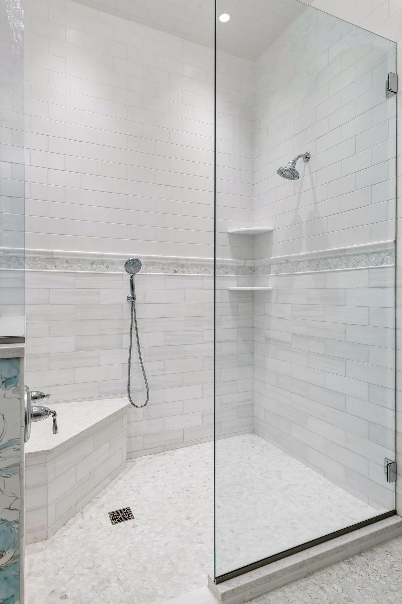 The large, tiled shower features a zero-entry threshold and built-in bench.