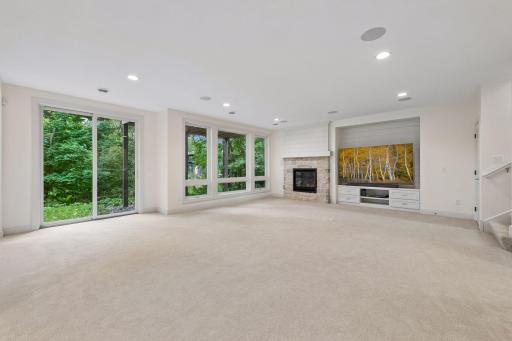 Downstairs, the walkout lower level offers a second Family Room with a gas fireplace and custom entertainment center.