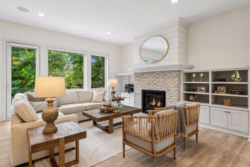 The inviting family room features a gas fireplace flanked by custom built-ins.