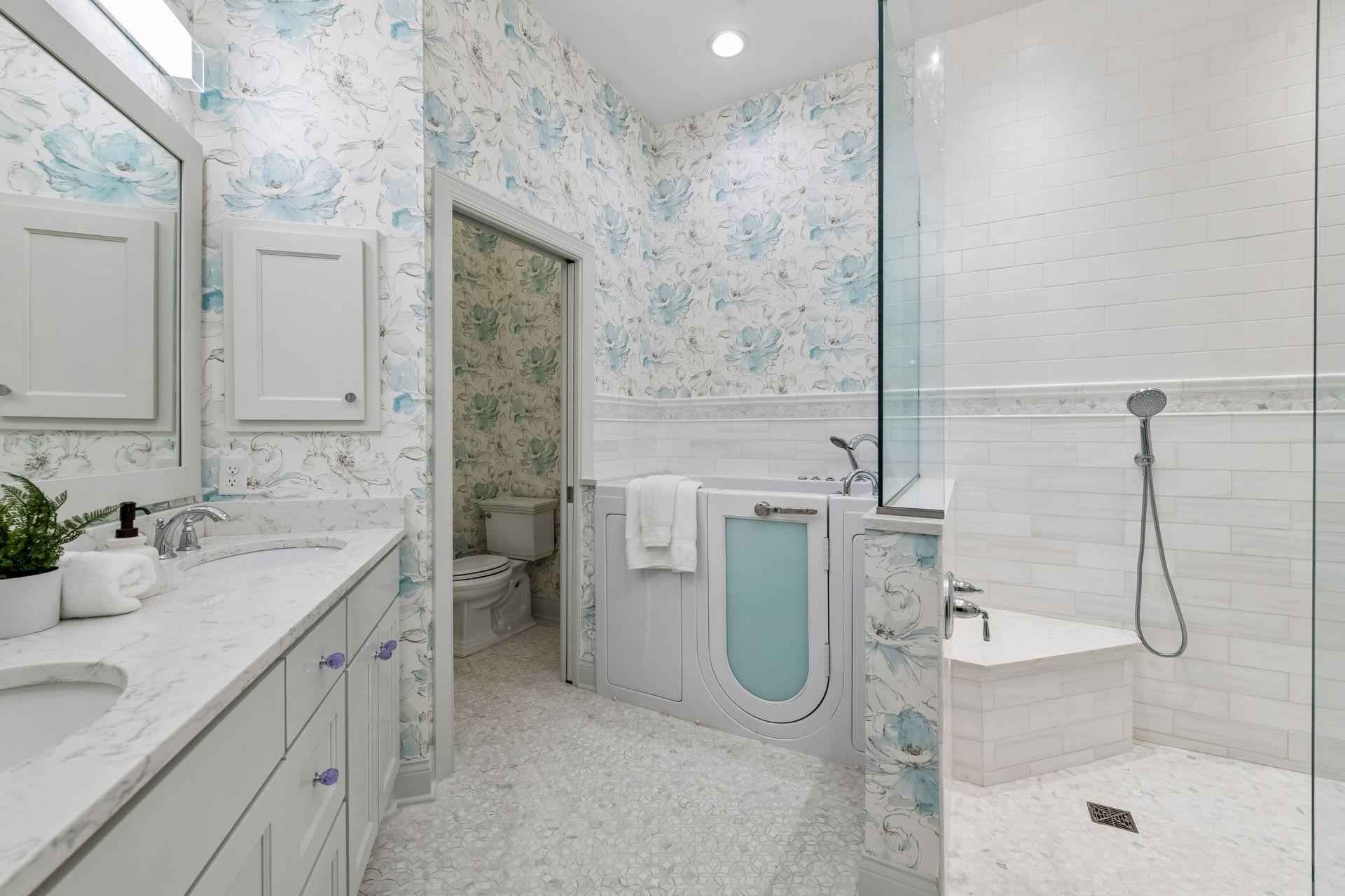 The Primary Bathroom has been beautifully updated with heated tile flooring, designer wallpaper and a therapeutic bathtub.