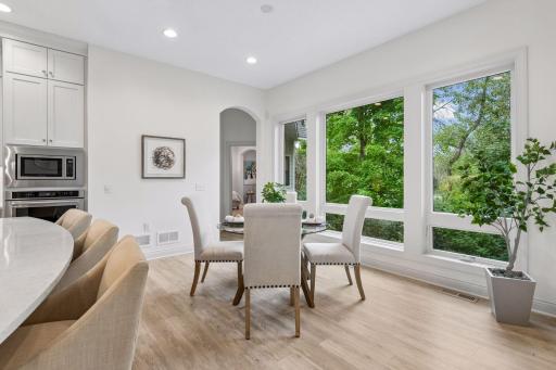 Floor-to-ceiling windows fill the Dining Room with natural light and treetop views.