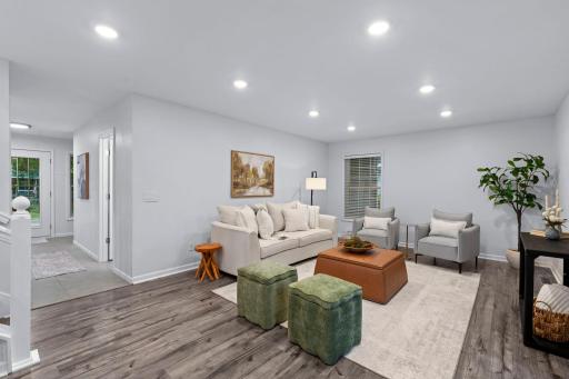 A welcoming entry opens to the main level, where sleek LVP flooring (2025) runs throughout for a crisp look and easy upkeep.