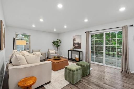The bright living room enjoys beautiful natural light and walkout access to the patio.