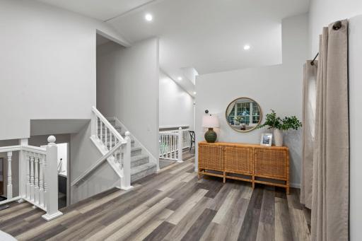 Upstairs, the kitchen and dining areas flow naturally together beneath a vaulted ceiling.