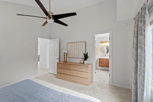 The spacious primary suite stands out with 12-ft vaulted ceilings, a walk-in closet, and a private bath.