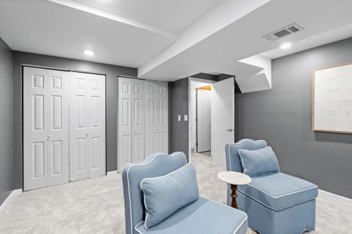 The laundry area is equally functional, with a utility sink, cabinetry, counterspace, shelving, and Frigidaire washer and dryer.